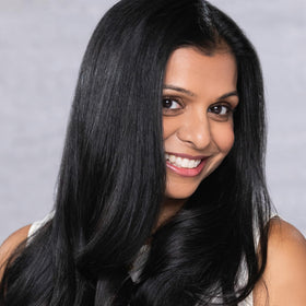 EVOLVh applied to wet hair in salon demonstrating smoothing action