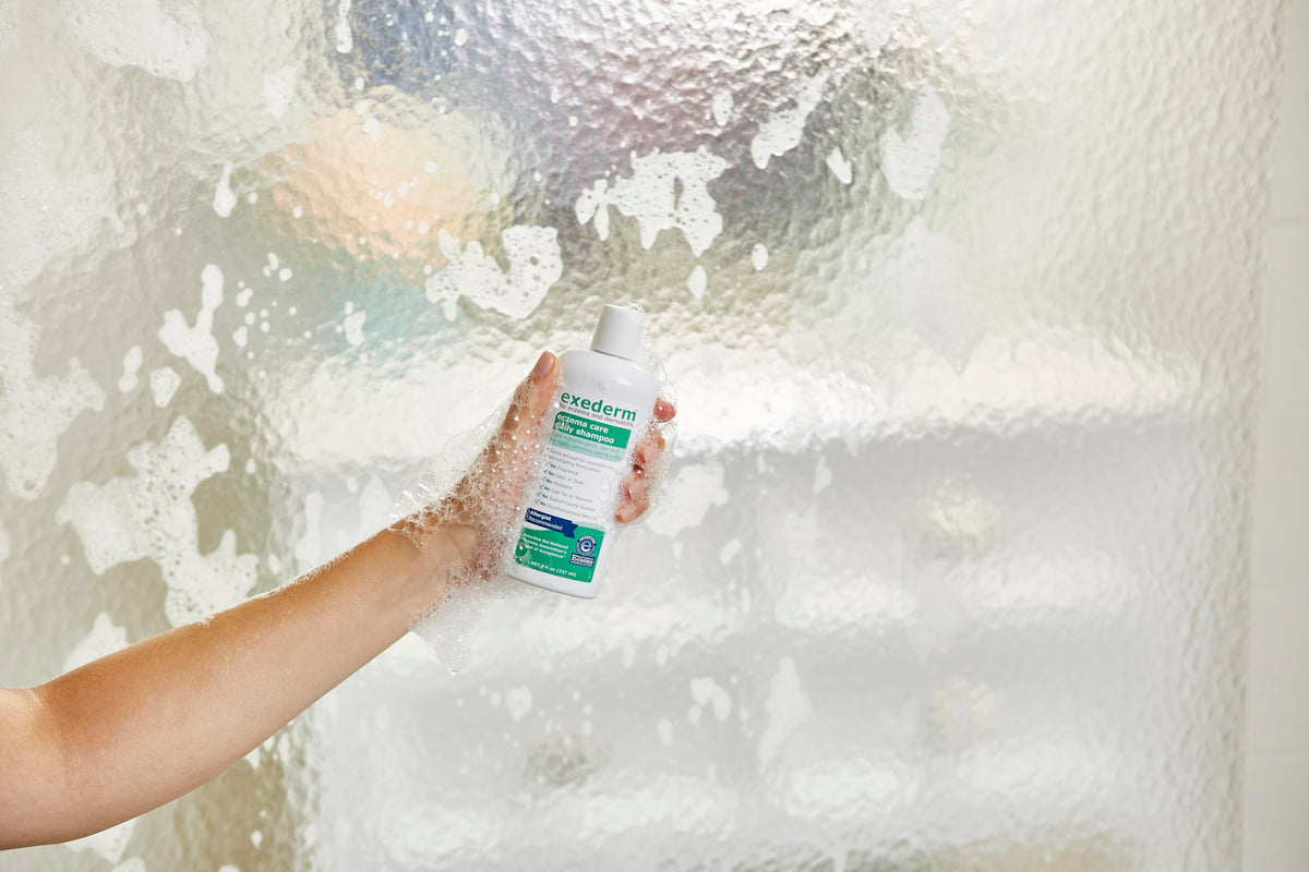 Person applying Exederm in shower demonstrating calming scalp care