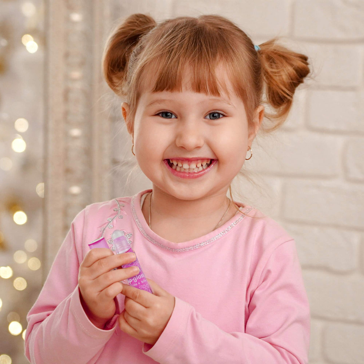 Expressions Girl size comparison with coin showing compact tubes fit in small hands