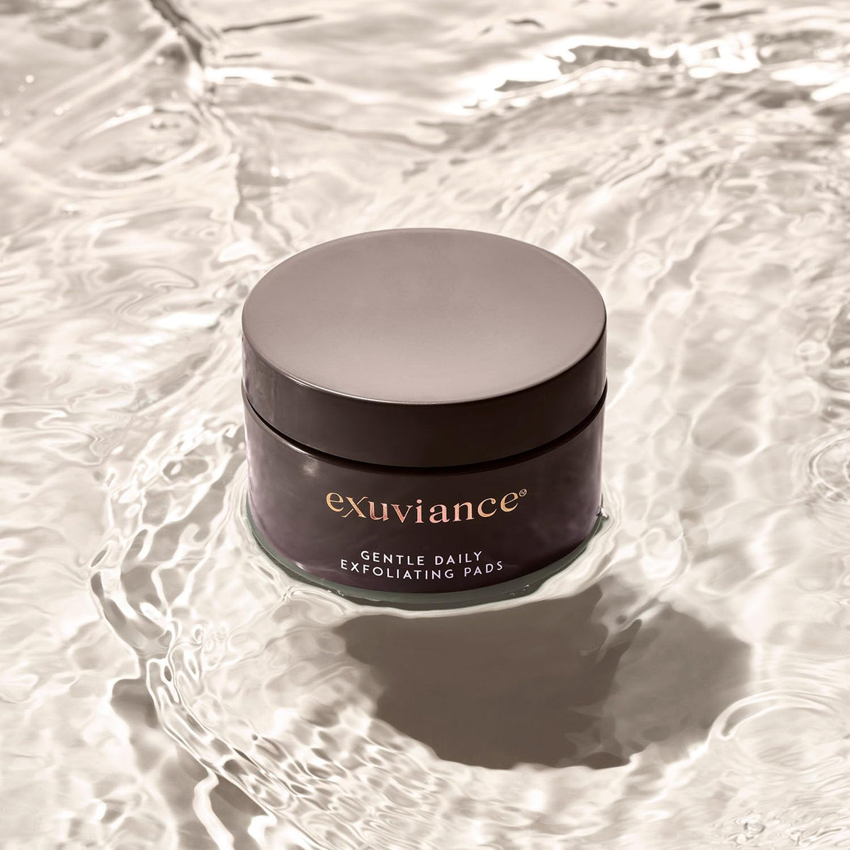 EXUVIANCE on bathroom vanity staged with skincare items suggesting daily routine integration