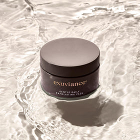 EXUVIANCE on bathroom vanity staged with skincare items suggesting daily routine integration