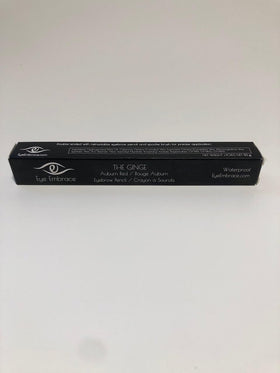Eye Embrace pencil next to coin showing compact travel-friendly size