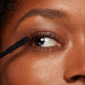 Eyeko Beach Waterproof Mascara on model showing lifted, lengthened lashes for natural drama