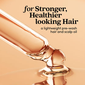 Fable & Mane close-up of oil texture on fingertips, demonstrates lightweight absorption