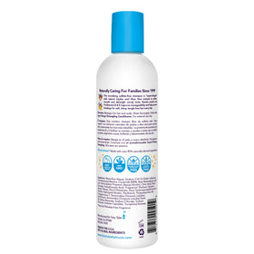 Fairy Tales Tangle Tamer bottle next to a coin to show 12 oz scale and convenient pump