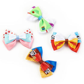 Hand holding Fancheer bow showing scale and suitable size for toddlers