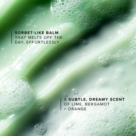 Hand spreading Farmacy Green Clean balm to show how it melts makeup gently