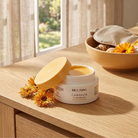 FARMASi open jar texture of rich calendula cream, shows non-sticky balm feel