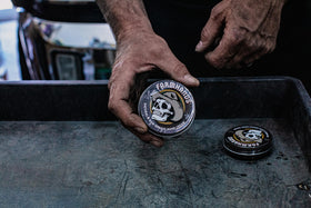 Farmhands tin next to gardening gloves showing hardworking hands benefit