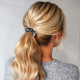 Fashey hair ties inside jewelry pouch suggesting protective storage and care