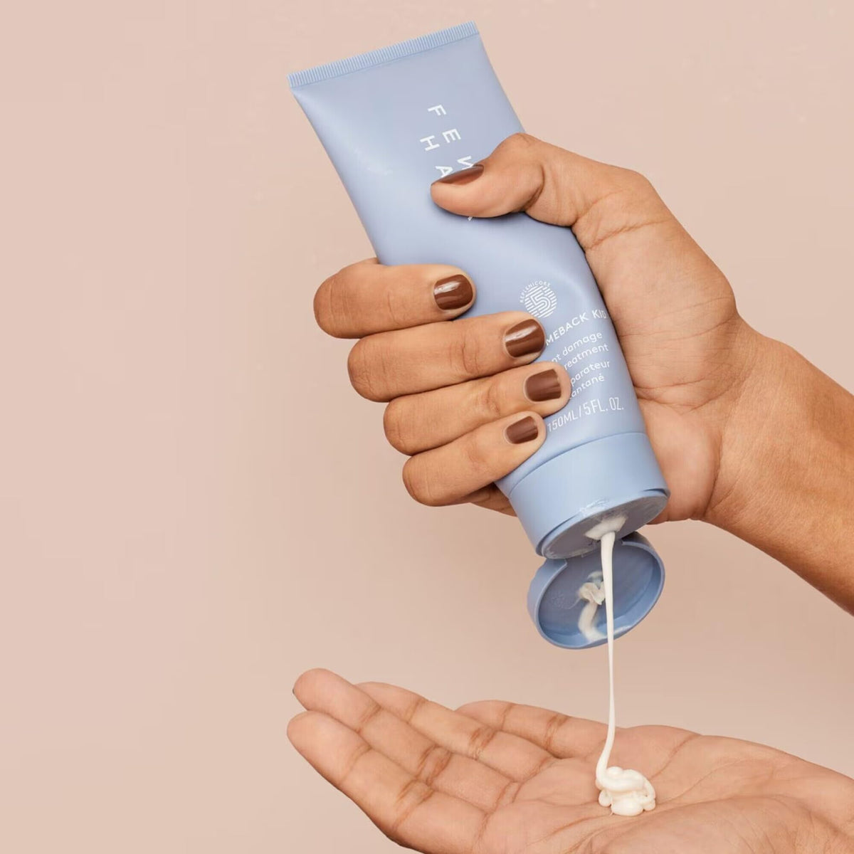 FENTY BEAUTY 150 mL size beside common item to show scale and travel benefit
