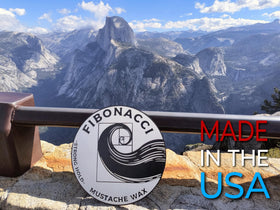Fibonacci Mustache Wax next to coin for size comparison and travel-friendly capacity