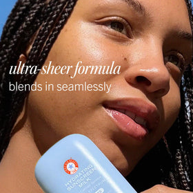 First Aid Beauty 1.7 oz bottle in a hand showing travel-friendly size