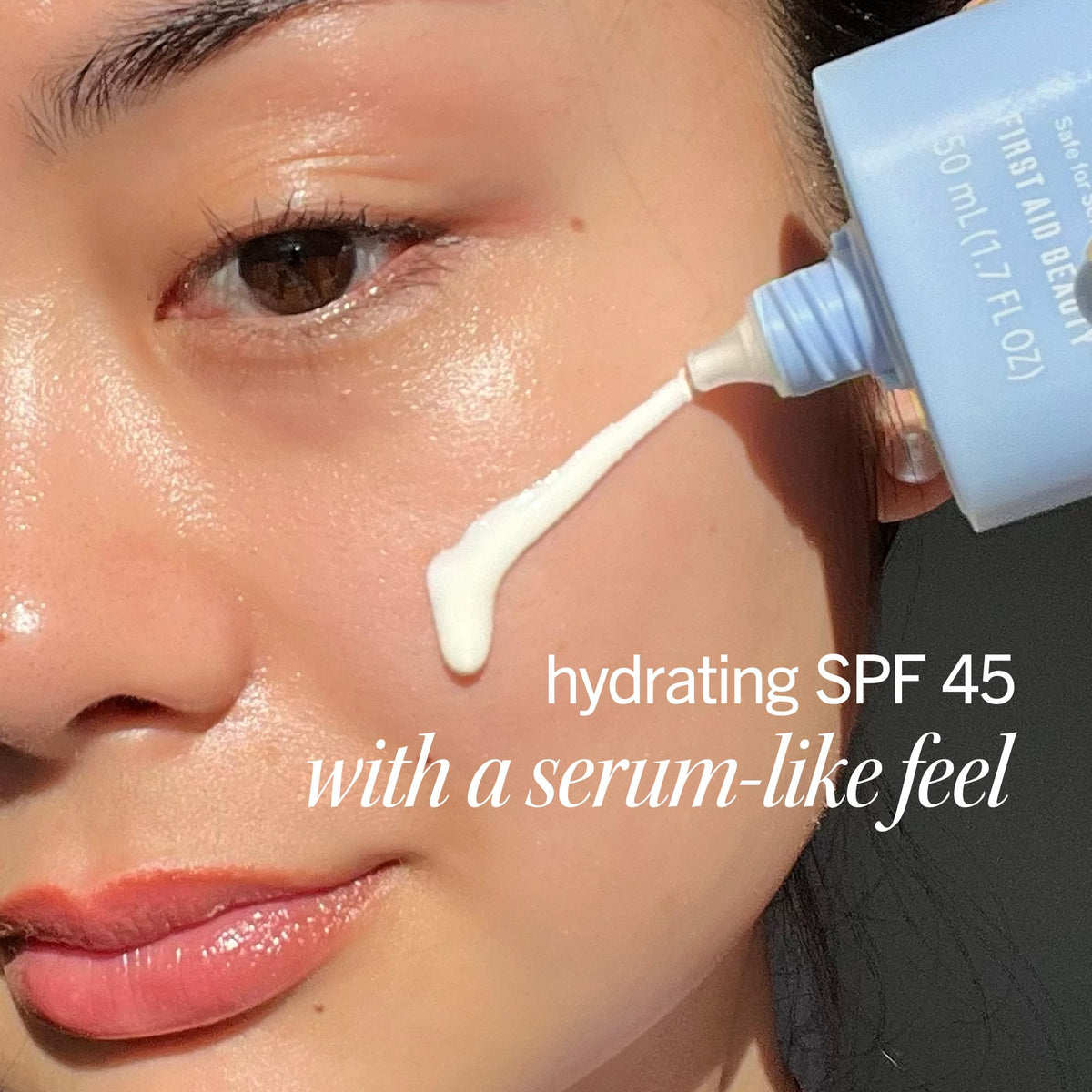 First Aid Beauty dispensing sunscreen milk demonstrating lightweight texture
