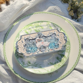 Flower Knows palette held in hand to show compact size and travel convenience