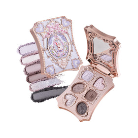 Flower Knows compact front view showing embossed bunny garden and mother-of-pearl finish, elegant gift appeal