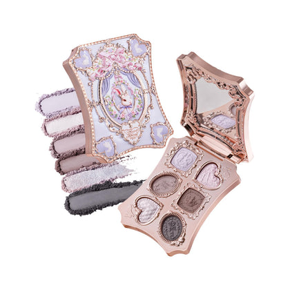 Flower Knows compact front view showing embossed bunny garden and mother-of-pearl finish, elegant gift appeal