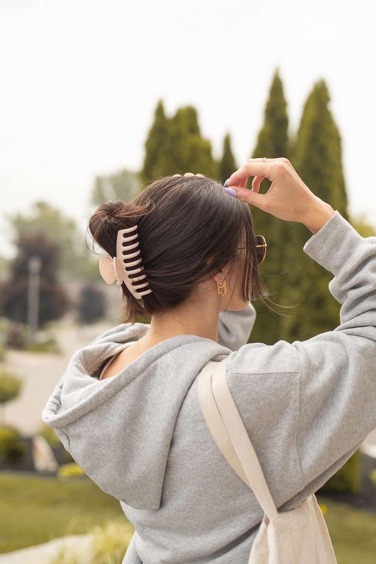 FRAMAR clip securing thick hair in a high bun, creates easy updo