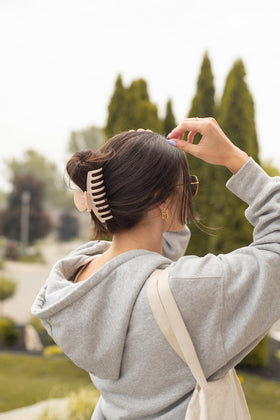FRAMAR clip securing thick hair in a high bun, creates easy updo