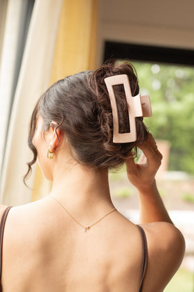 FRAMAR held in hand to show lightweight comfort and portability