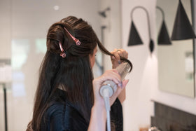 Framar clip used by stylist during blowout for steady sectioning