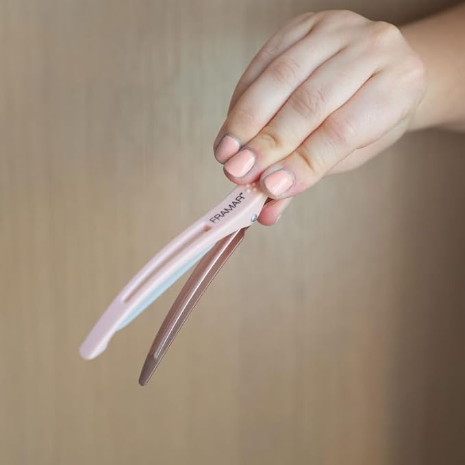 FRAMAR clip in hand to show size and secure-grip practicality benefit