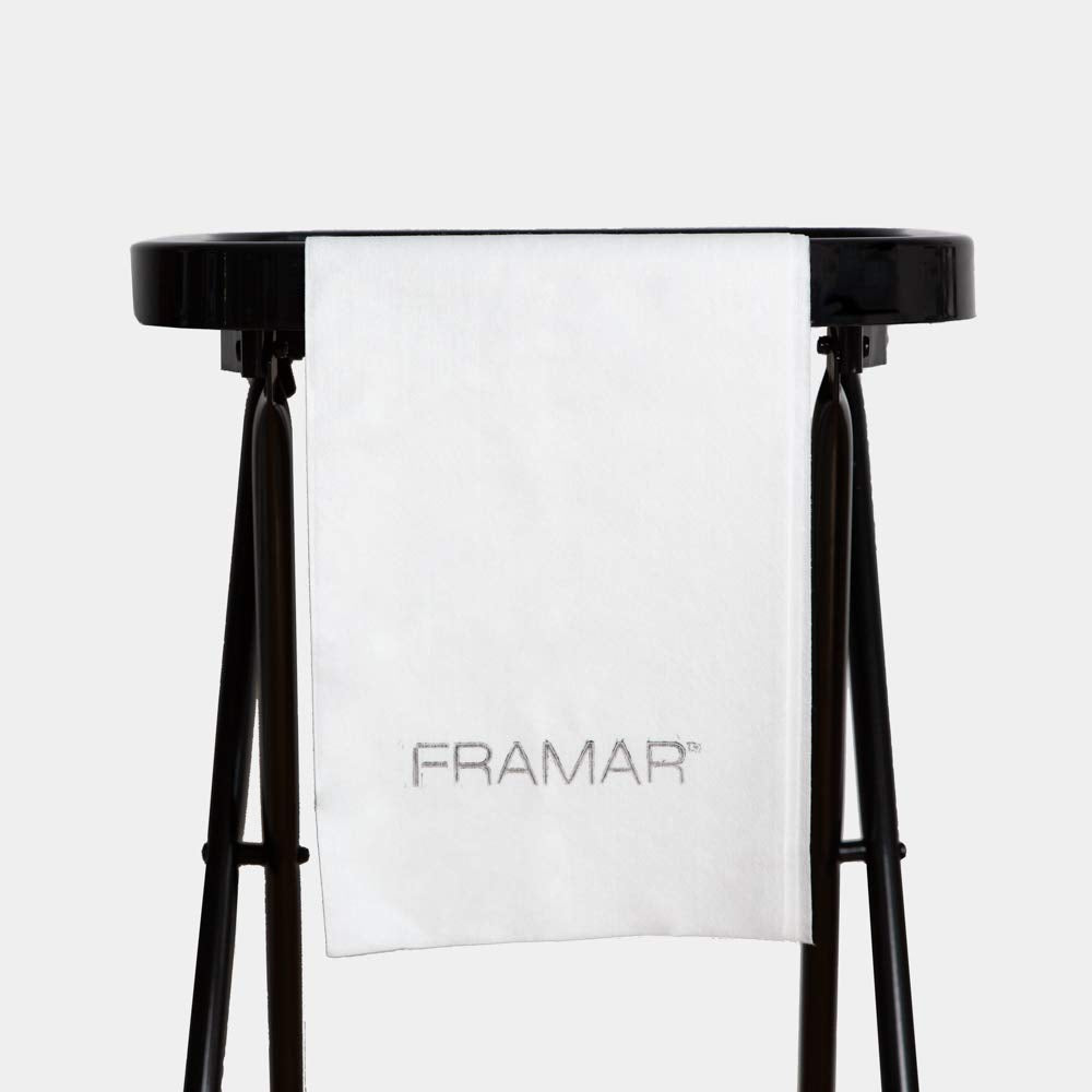 FRAMAR towel held by hand demonstrating size and lightweight feel