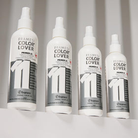 Hand spraying Framesi primer on damp hair demonstrating detangling and heat protection