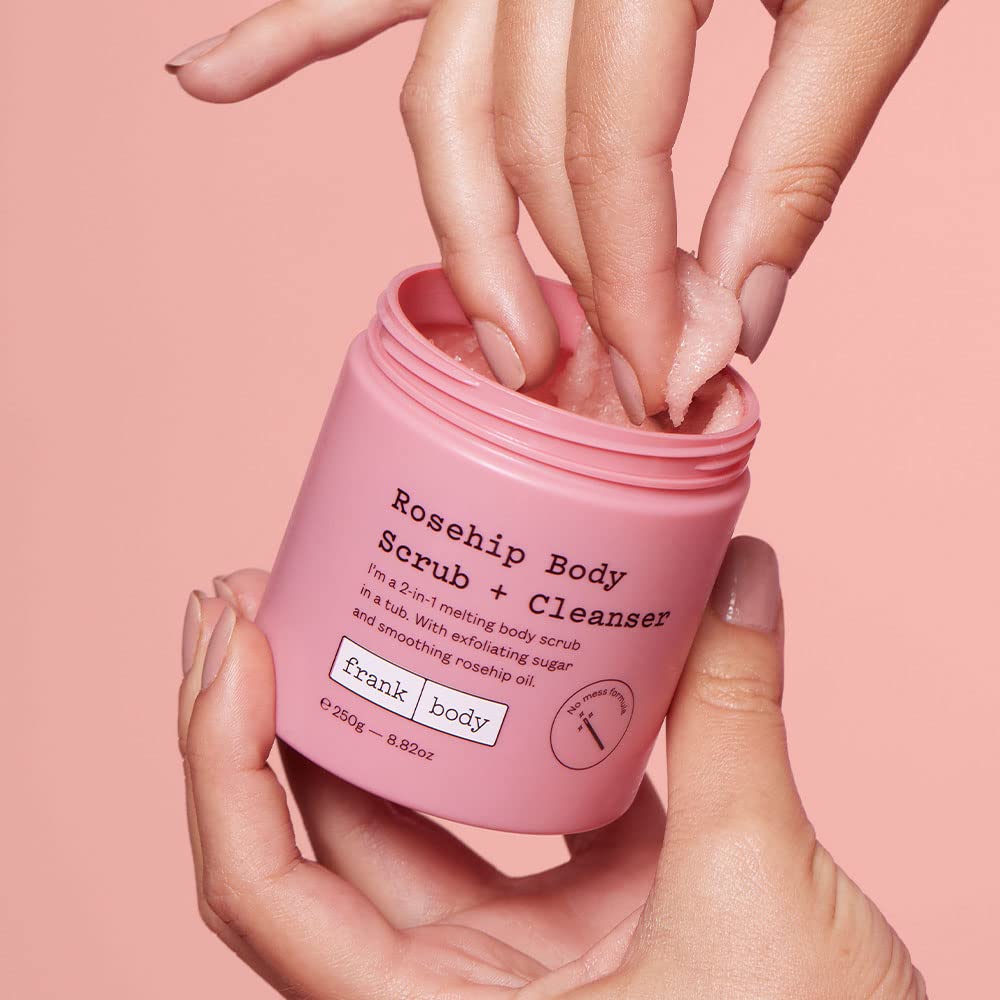 frank body 250g jar next to palm for size and portability clarity