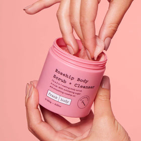 frank body 250g jar next to palm for size and portability clarity