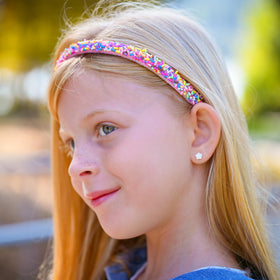 FROG SAC flatlay of pink, purple, blue, rainbow headbands for outfit coordination