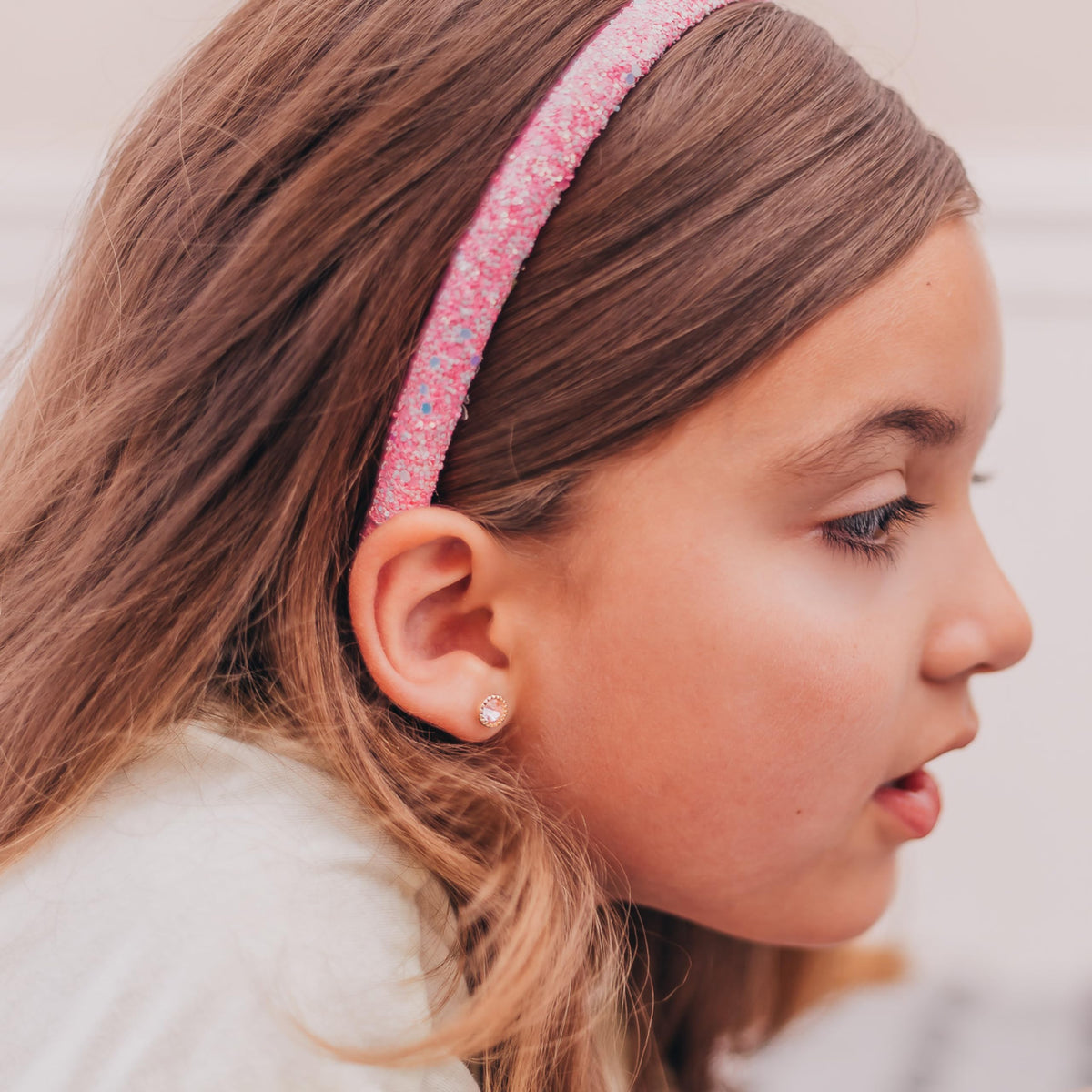 FROG SAC child wearing headband outdoors showing secure fit during play
