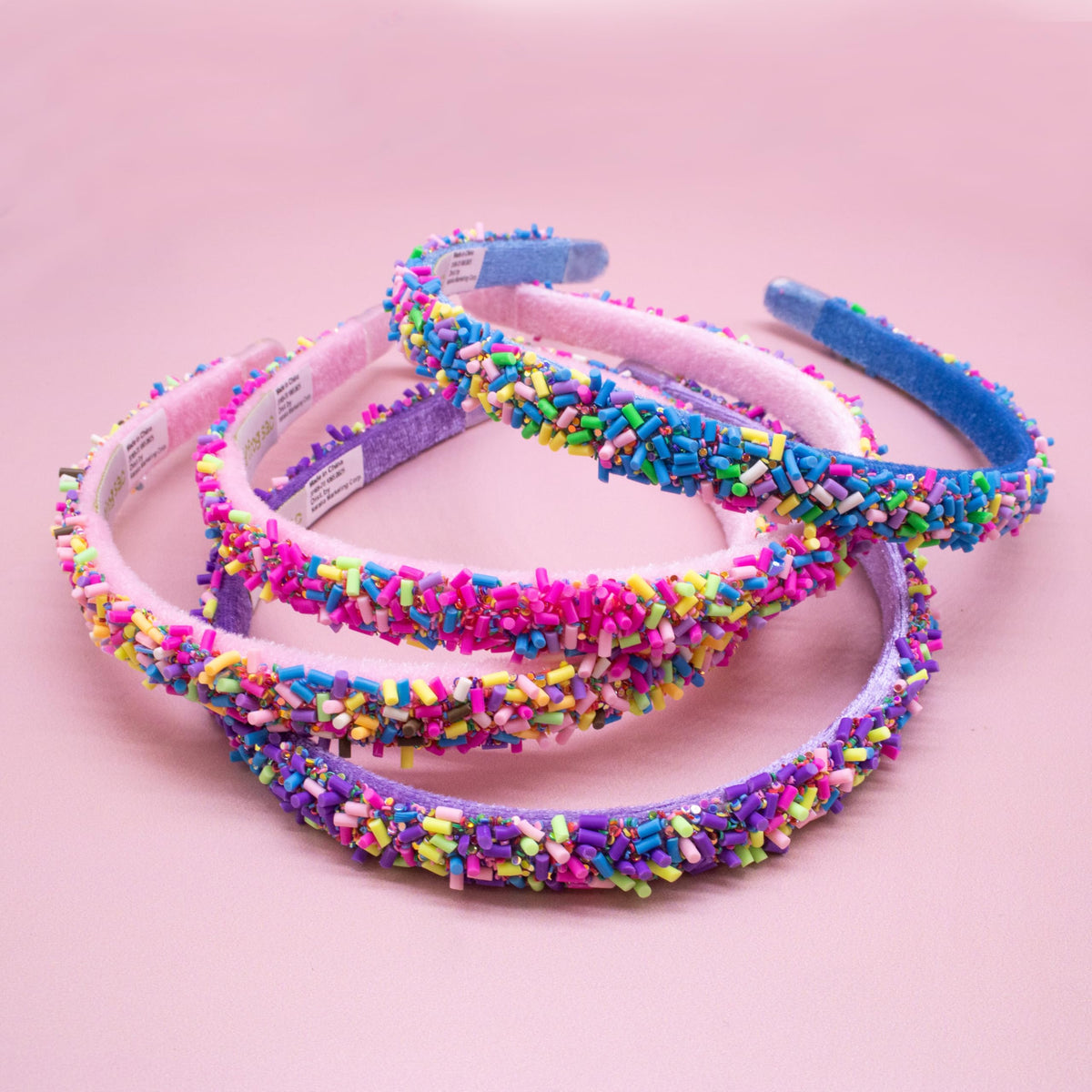 FROG SAC girl at party wearing a sparkly headband, festive accessory boosting confidence