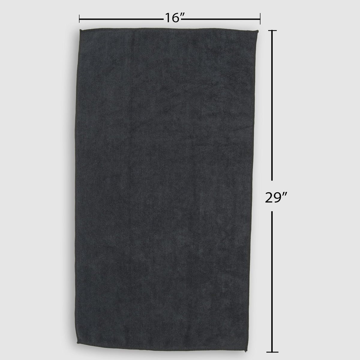 Fromm towel beside hand showing 16 by 29 inch size and portability
