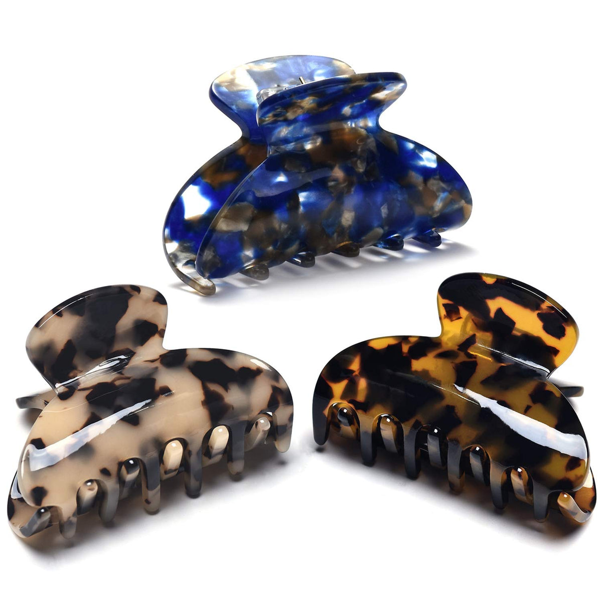 Fsmiling front view of three tortoise claw clips showing patterns and finish