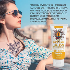 Person at the beach applying FUKEVY sunscreen to tattoos for outdoor protection