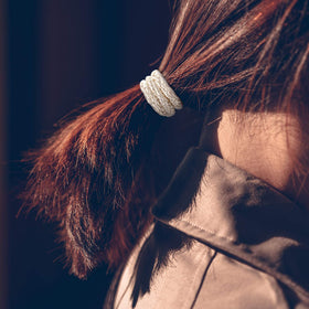 Funtopia hair ties on hand showing stretch and true-to-size scale