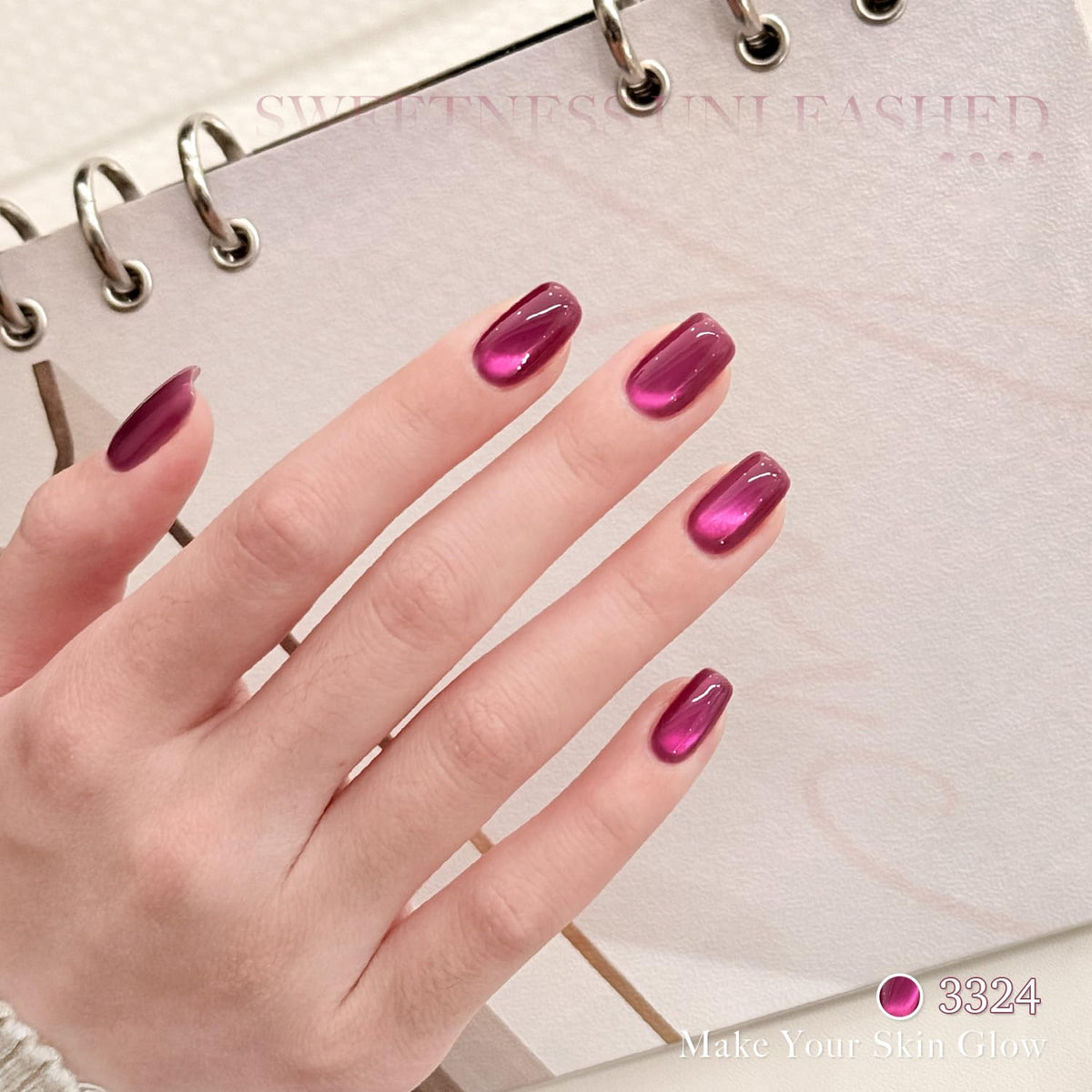 GAOY cat-eye magnet held over wet polish creating magnetic stripe effect for dramatic nails