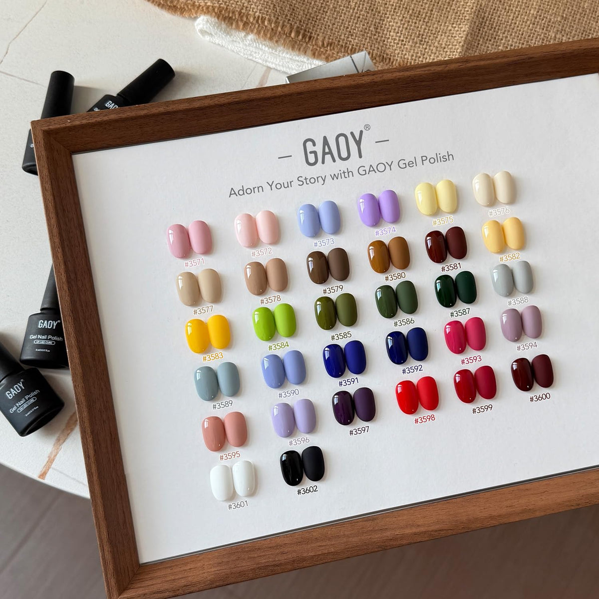 GAOY bottles next to coin showing compact bottle size for travel