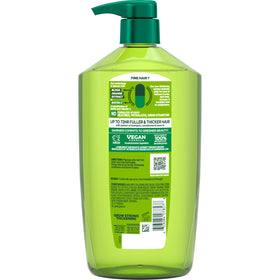 Person styling hair with Garnier Fructis for fuller-looking volume benefit
