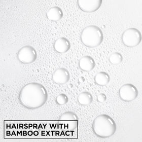 Garnier Fructis hairspray securing an updo to demonstrate long-lasting hold and frizz control