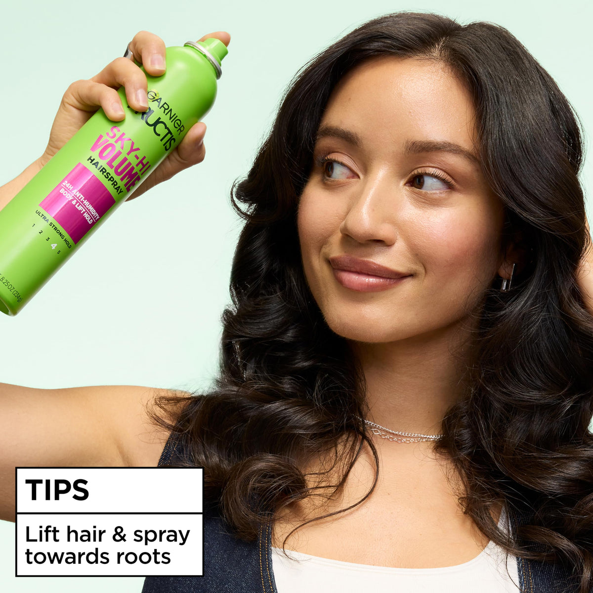 Garnier Fructis next to hairbrush showing size and styling convenience