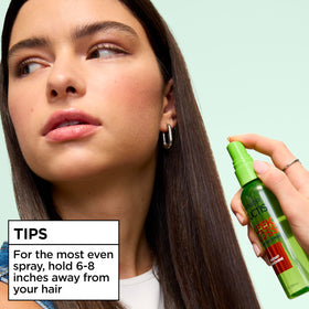 Garnier Fructis held in hand to show 3 fl oz size and portability
