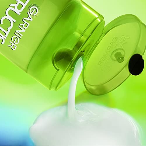 Garnier Fructis 22 fl oz bottle next to hand showing size