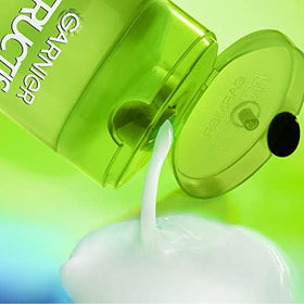 Garnier Fructis 22 fl oz bottle next to hand showing size