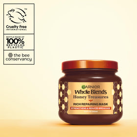 Garnier whole blends hand holding tub showing scale and travel convenience