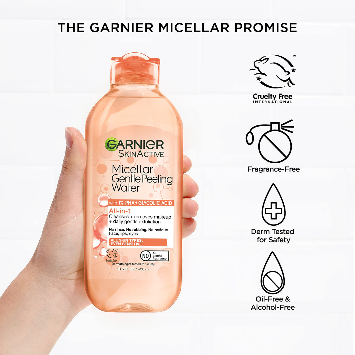 Hand using Garnier micellar water to remove makeup quickly