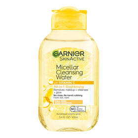 Garnier mini beside passport showing travel-friendly size benefit