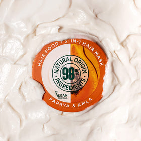 Garnier applied to wet hair as a mask demonstrating restorative hydration benefit
