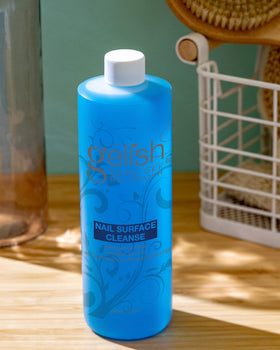 Gelish cleanser in use wiping nail to remove tacky residue for smooth glossy finish